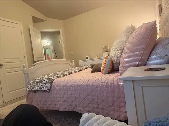 a bedroom with a bed and a mirror