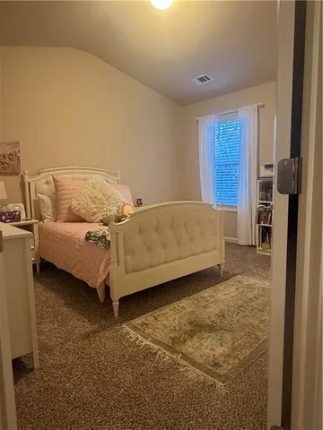 a bedroom with a bed and a cabinets