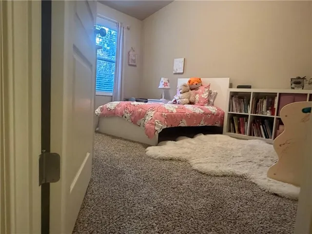 a bedroom with a bed and a book shelf