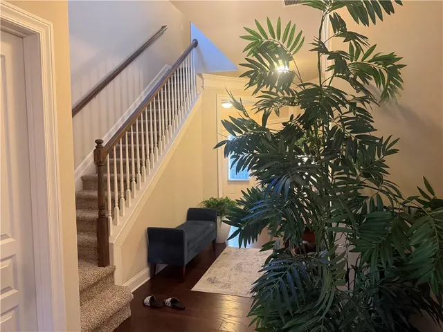 a view of staircase with wooden floor and a potted plant
