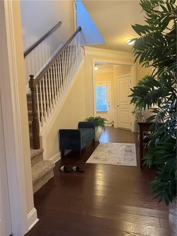 a view of entryway and hall with wooden floor