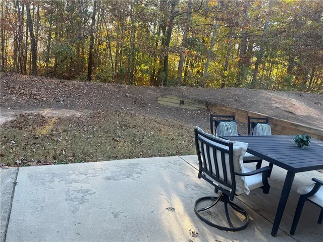 a view of a chairs and table in the backyard