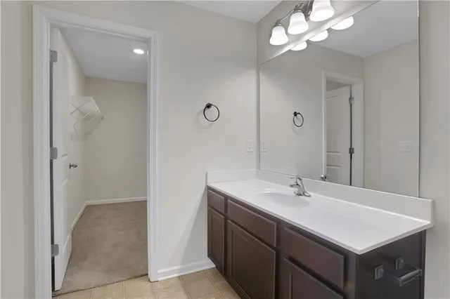 a bathroom with a sink a light fixture and a mirror