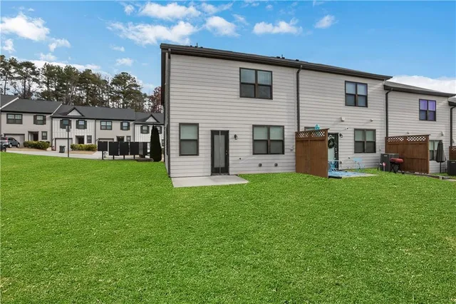 a front view of house with yard and outdoor seating