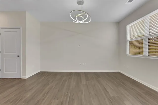 a view of a room with wooden floor and white walls