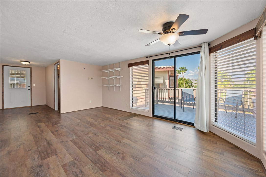 2000 Ramar Road, Unit 587 Bullhead City, AZ 86442 - Photo 14 of 79 Bright living area with vaulted ceiling and ceiling fan and Golf course and Mountain View?s with access to large deck
