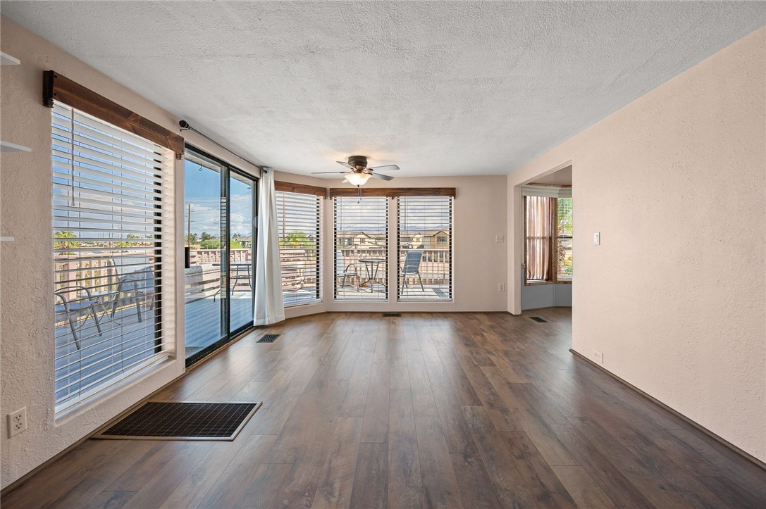 2000 Ramar Road, Unit 587 Bullhead City, AZ 86442 - Photo 15 of 79 Bright living area with vaulted ceiling and ceiling fan and Golf course and Mountain View?s with access to large deck