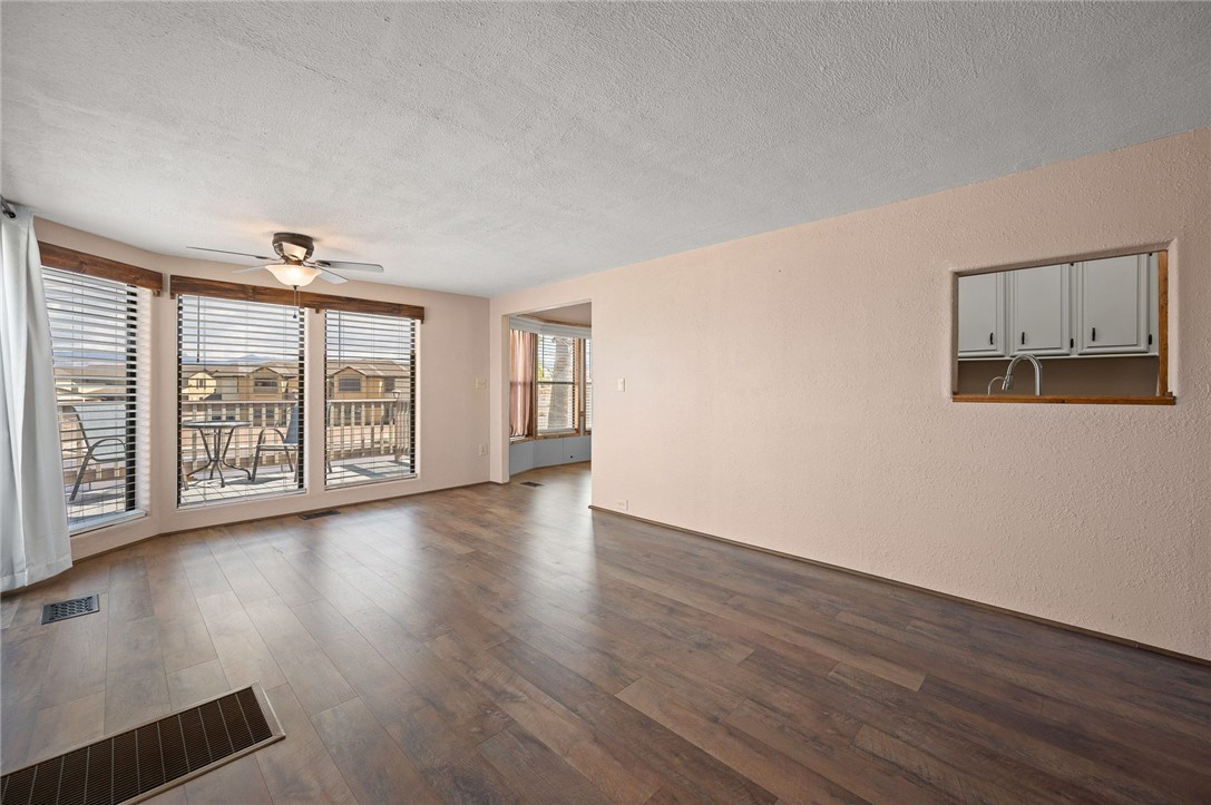 2000 Ramar Road, Unit 587 Bullhead City, AZ 86442 - Photo 16 of 79 Bright living area with vaulted ceiling and ceiling fan and Golf course and Mountain View?s with access to large deck
