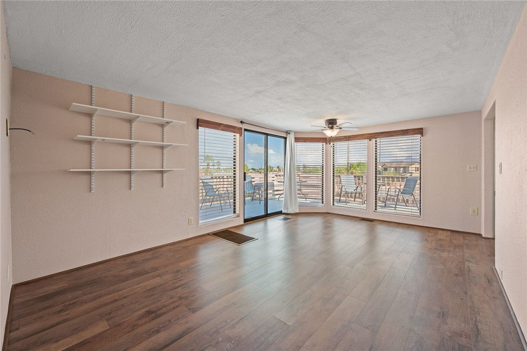2000 Ramar Road, Unit 587 Bullhead City, AZ 86442 - Photo 17 of 79 Bright living area with vaulted ceiling and ceiling fan and Golf course and Mountain View?s with access to large deck