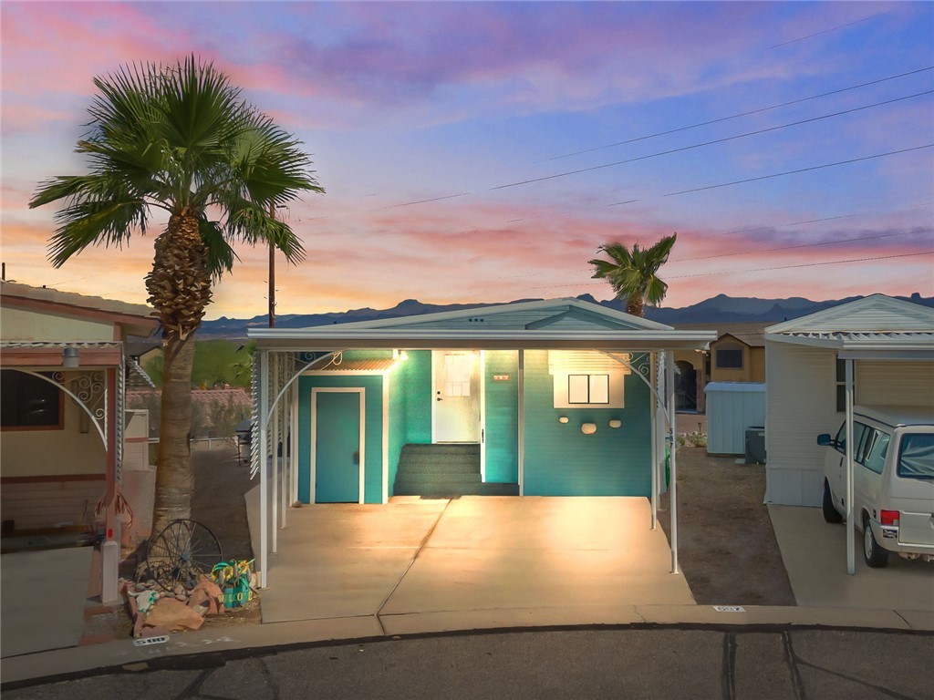 2000 Ramar Road, Unit 587 Bullhead City, AZ 86442 - Photo 2 of 79 Charming front entry with shaded double carport
? Front with carport: ?Double carport for covered parking convenience.