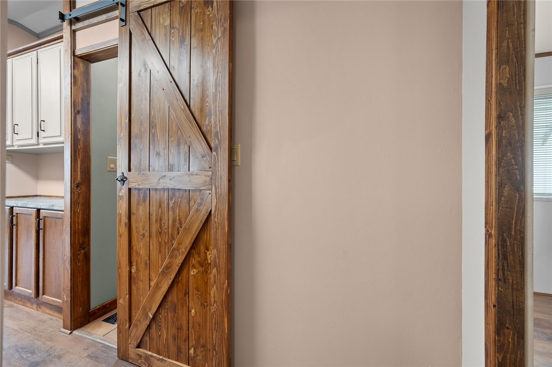 2000 Ramar Road, Unit 587 Bullhead City, AZ 86442 - Photo 28 of 79 Detailed view of a barn door and wood finished floors