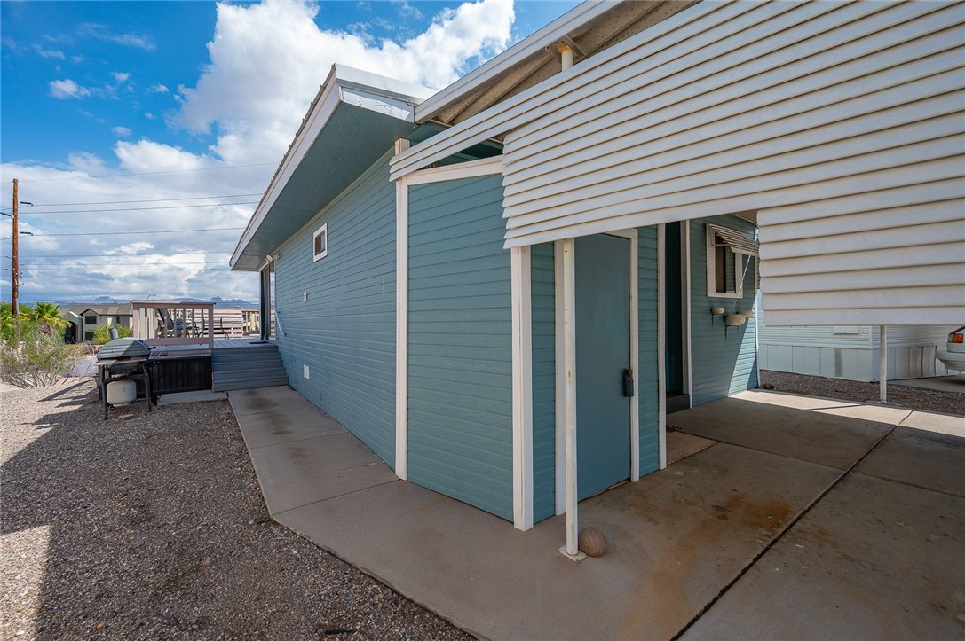 2000 Ramar Road, Unit 587 Bullhead City, AZ 86442 - Photo 39 of 79 View of property exterior featuring a deck