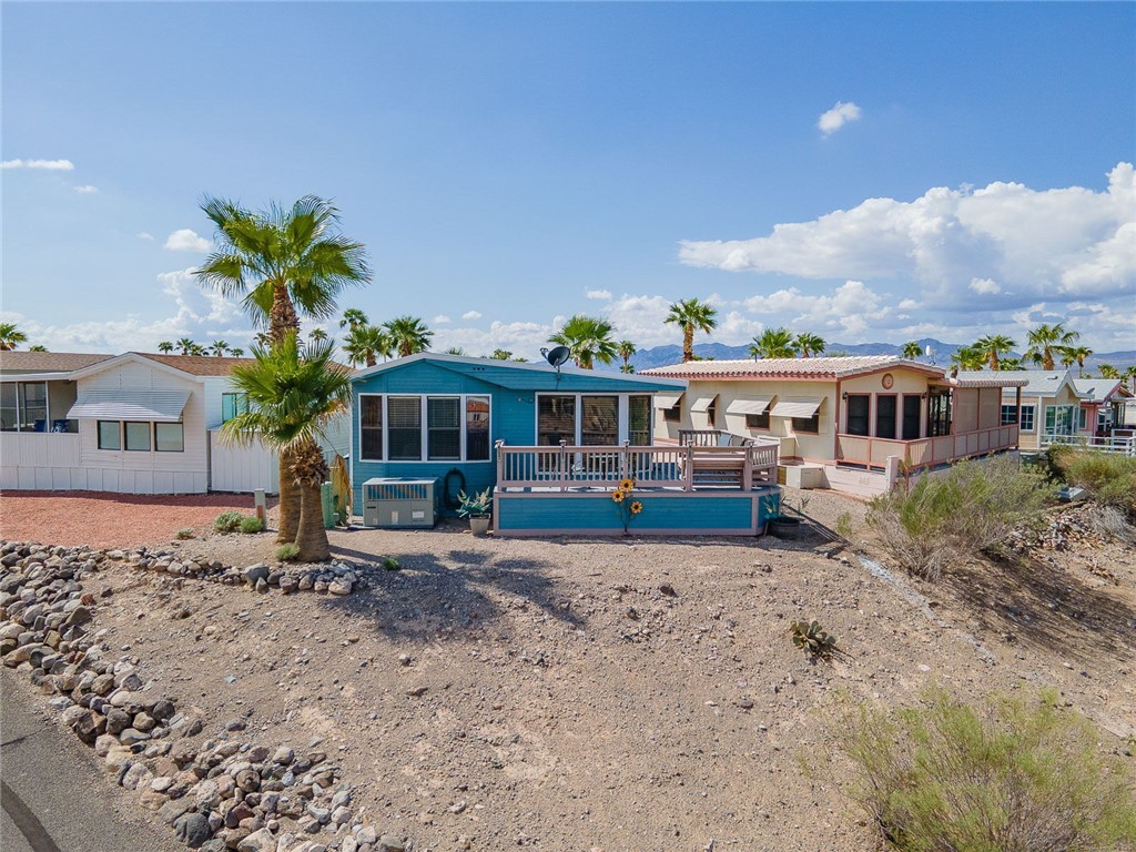2000 Ramar Road, Unit 587 Bullhead City, AZ 86442 - Photo 49 of 79 View of back of property with large deck and a plenty of videos to enjoy golf course and mountain views