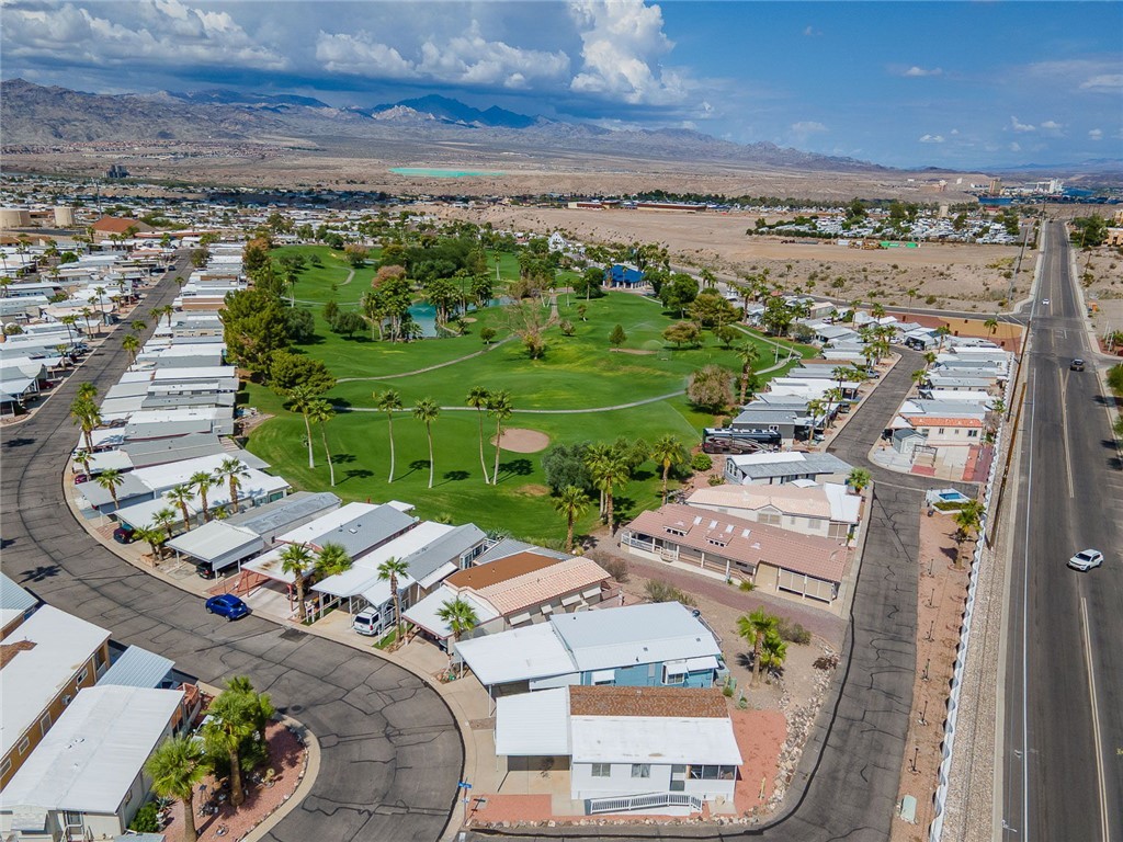 2000 Ramar Road, Unit 587 Bullhead City, AZ 86442 - Photo 62 of 79 Aerial view of residential area with a mountainous background and a local golf course