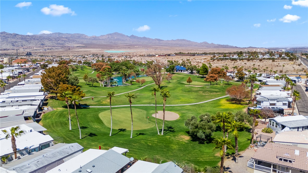 2000 Ramar Road, Unit 587 Bullhead City, AZ 86442 - Photo 66 of 79 Aerial perspective of suburban area with a local golf course and a water and mountain view