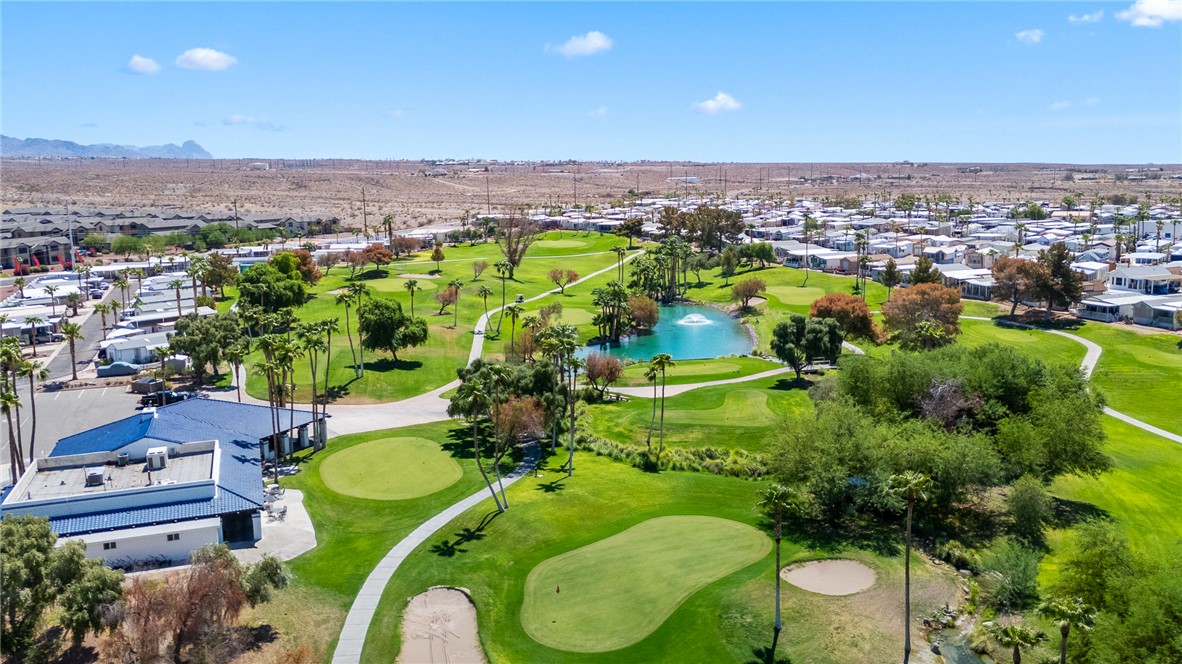 2000 Ramar Road, Unit 587 Bullhead City, AZ 86442 - Photo 68 of 79 Aerial perspective of suburban area featuring a large body of water and a golf course