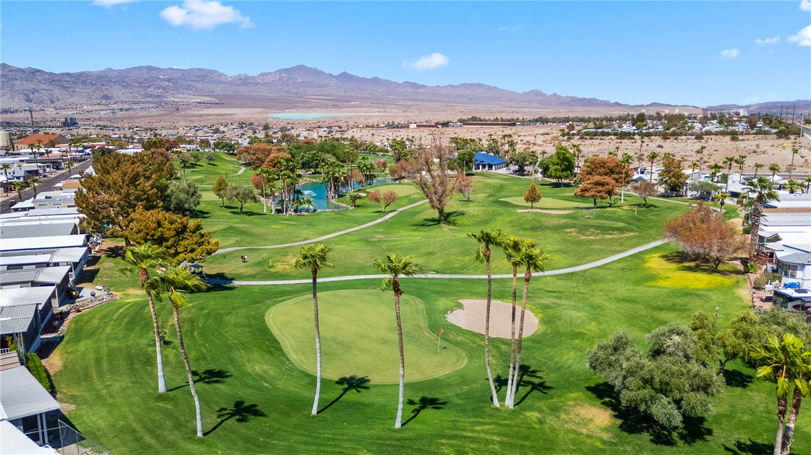 2000 Ramar Road, Unit 587 Bullhead City, AZ 86442 - Photo 69 of 79 Aerial view of property and surrounding area featuring a water and mountain view, nearby suburban area, and a golf club
