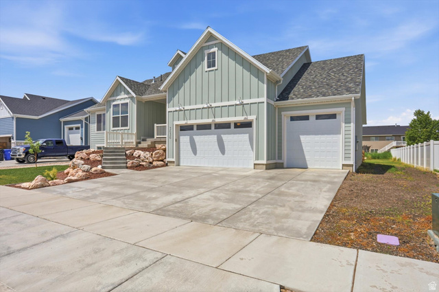 3636 West 910 South Syracuse, UT 84075 - Photo 3 of 70 Light green siding exterior with multiple gables and a dark shingle roof