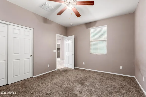 a view of a livingroom with a ceiling fan and window