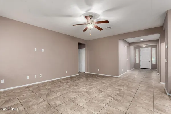 a view of an empty room with a ceiling fan