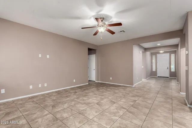 a view of an empty room with a ceiling fan