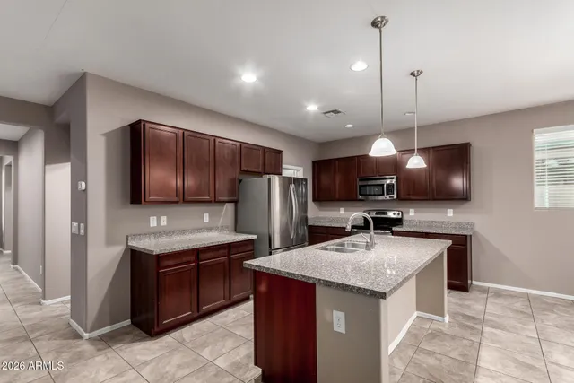 a kitchen with a sink stove and refrigerator