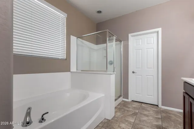 a bathroom with a bathtub and a shower