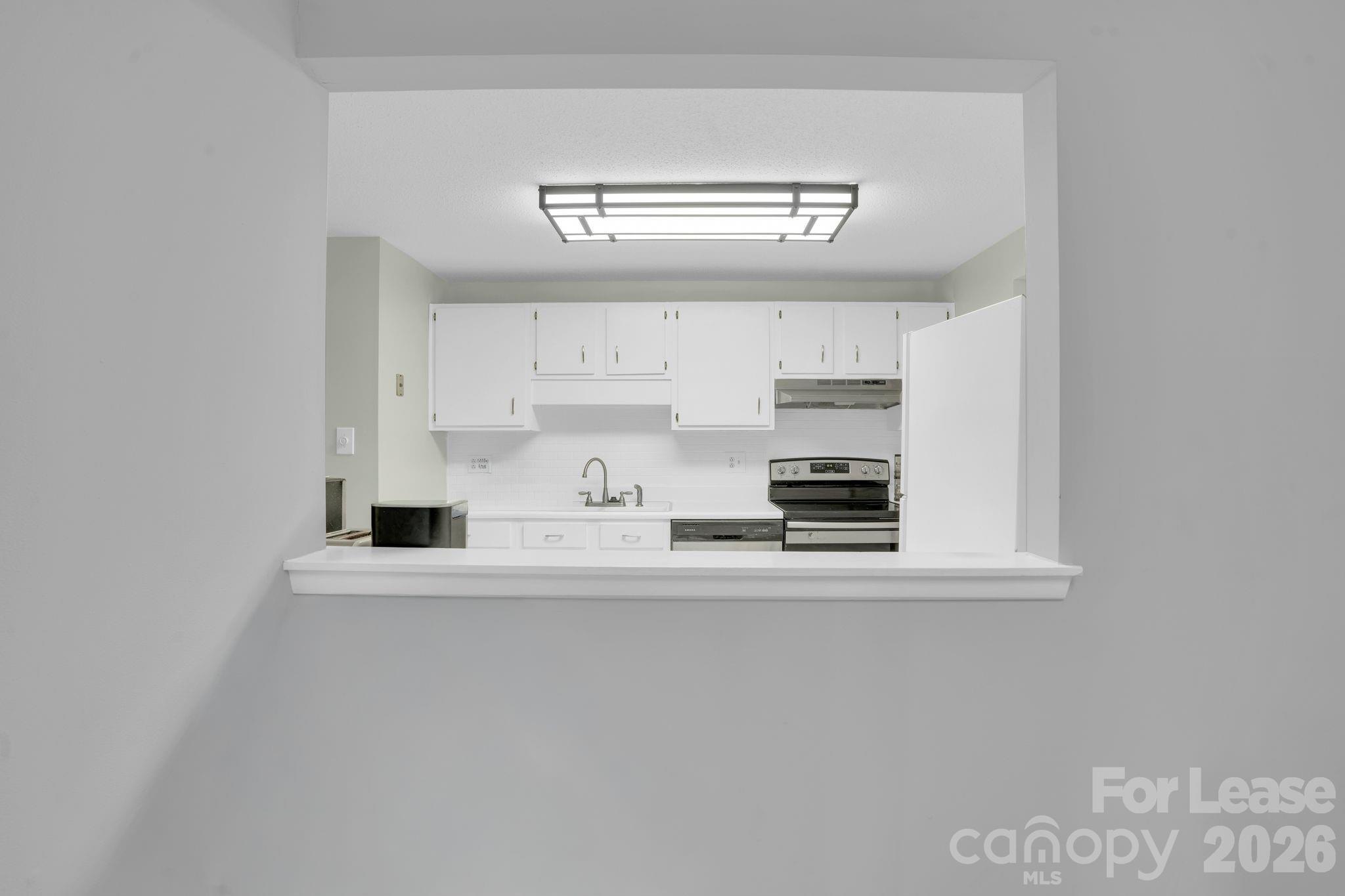 2427 Studley Road Charlotte, NC 28212 - Photo 15 of 30 a kitchen with stainless steel appliances a refrigerator and microwave