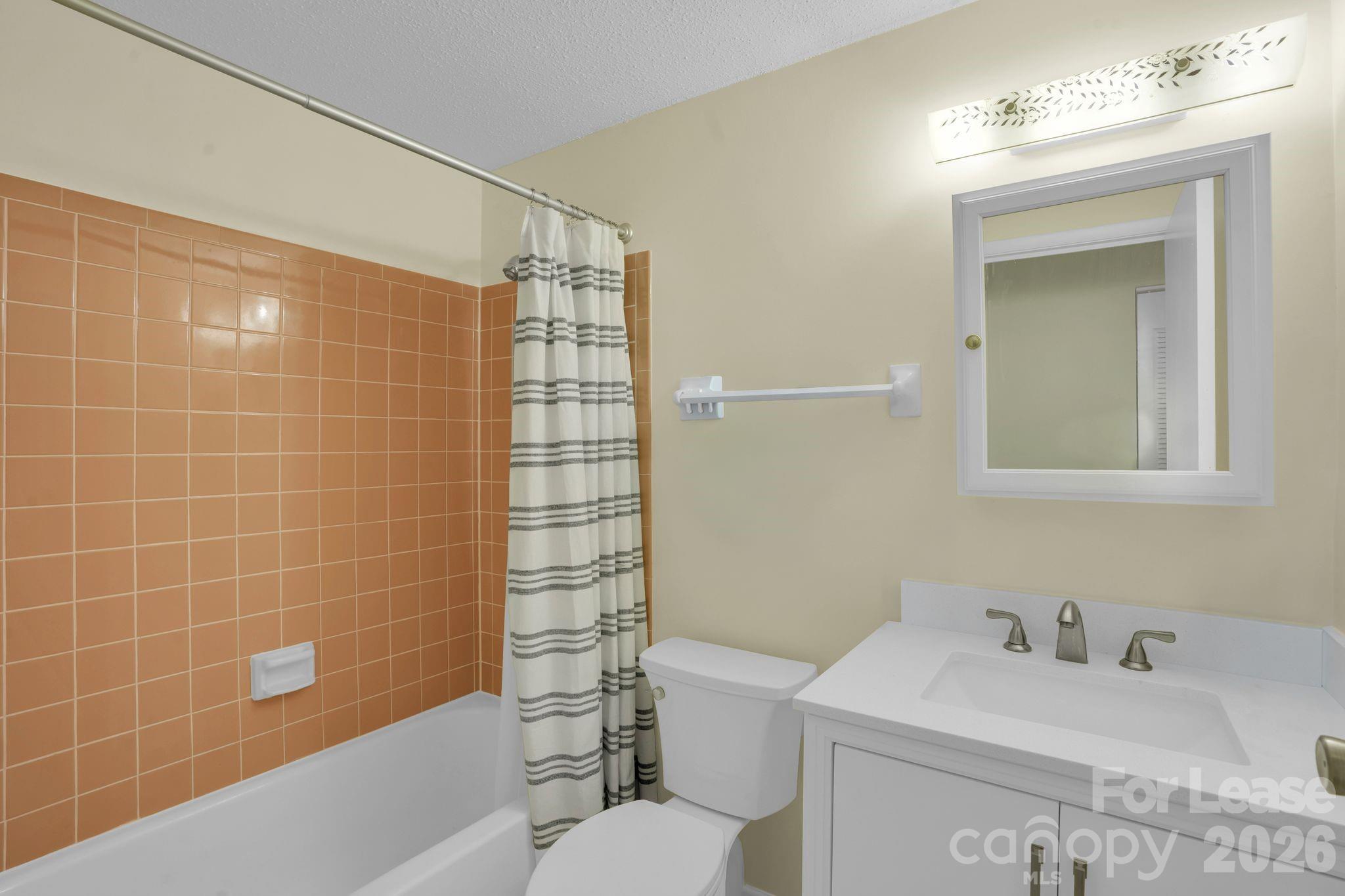 2427 Studley Road Charlotte, NC 28212 - Photo 20 of 30 a bathroom with a sink toilet vanity and shower