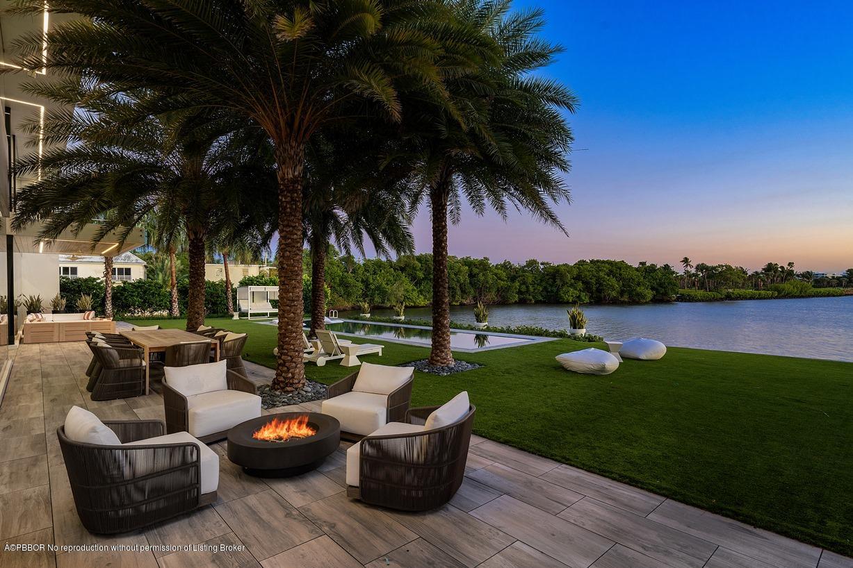 2299 Ibis Isle Road East Palm Beach, FL 33480 - Photo 2 of 37 a view of a patio with couches chair and fire pit