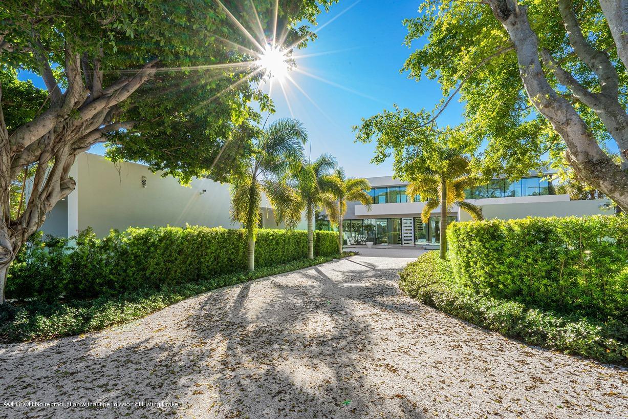 2299 Ibis Isle Road East Palm Beach, FL 33480 - Photo 12 of 37 a view of a house with a small yard and large trees