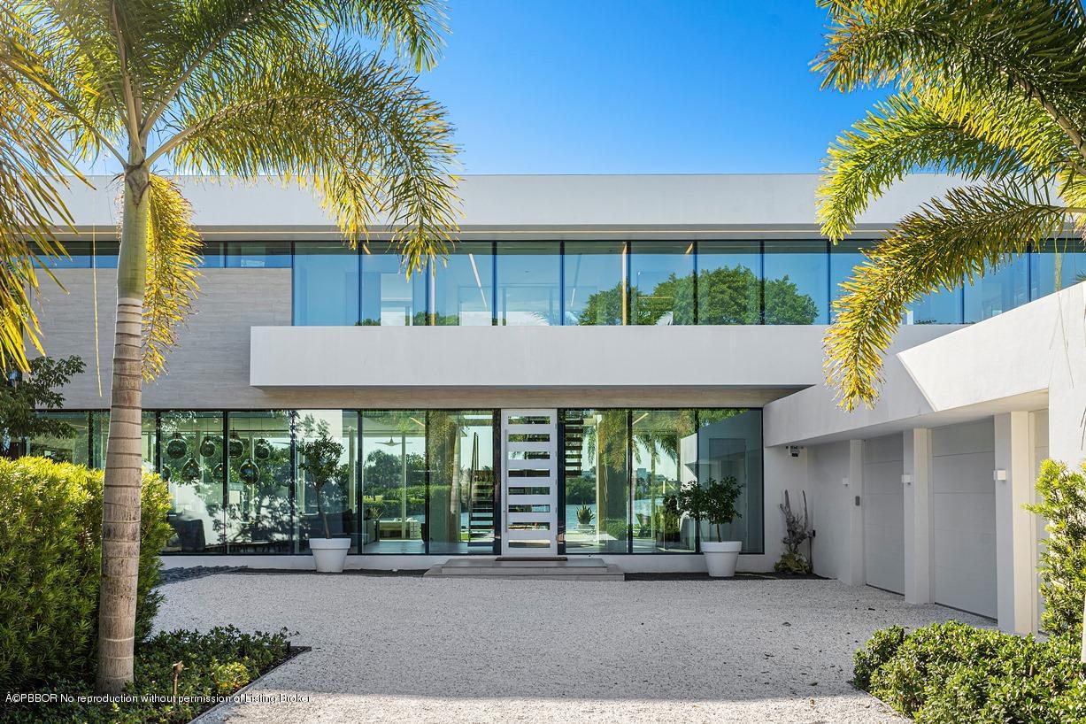 2299 Ibis Isle Road East Palm Beach, FL 33480 - Photo 13 of 37 a front view of a house with a garden and patio