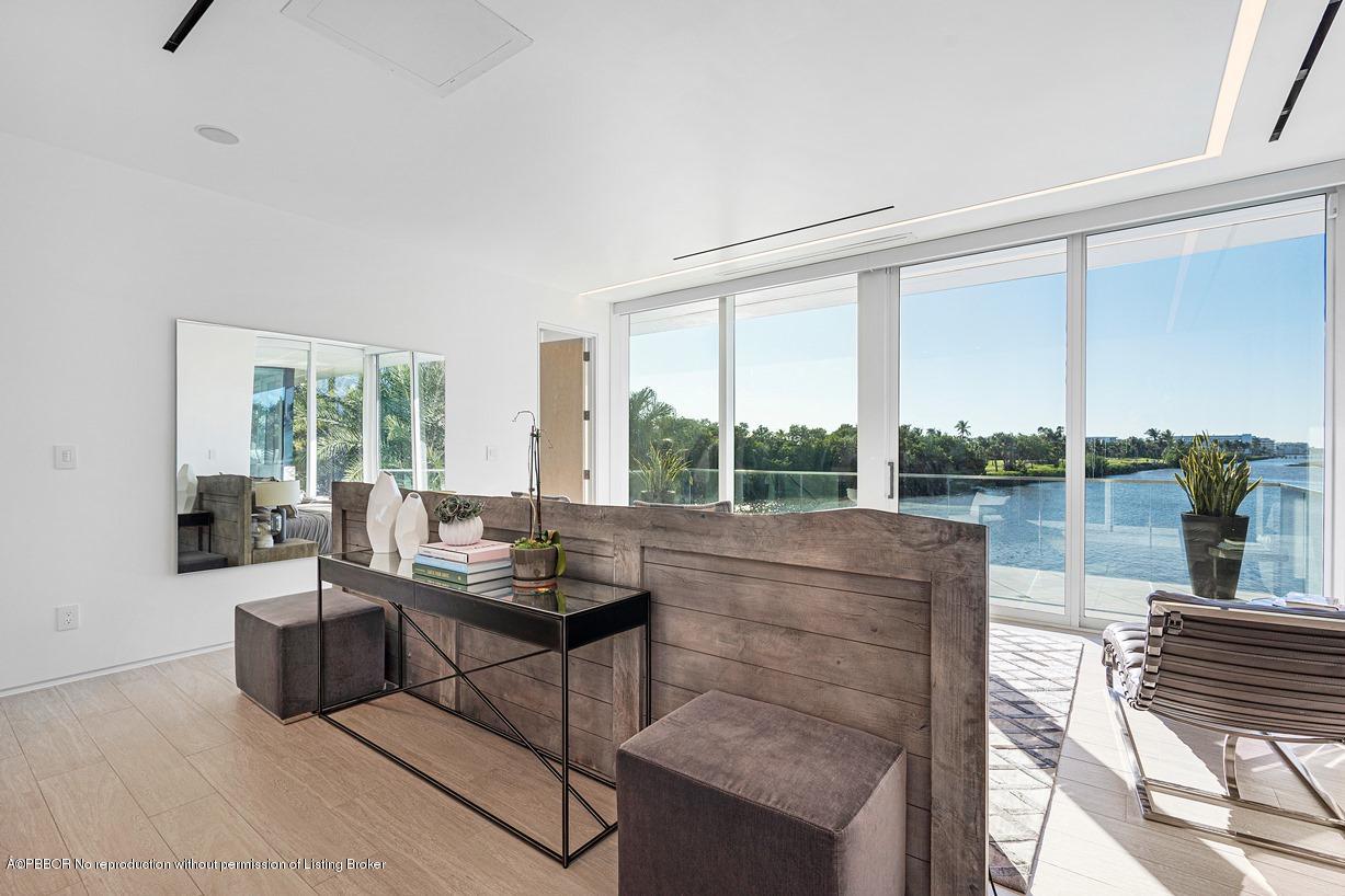 2299 Ibis Isle Road East Palm Beach, FL 33480 - Photo 20 of 37 a living room with furniture and a floor to ceiling window