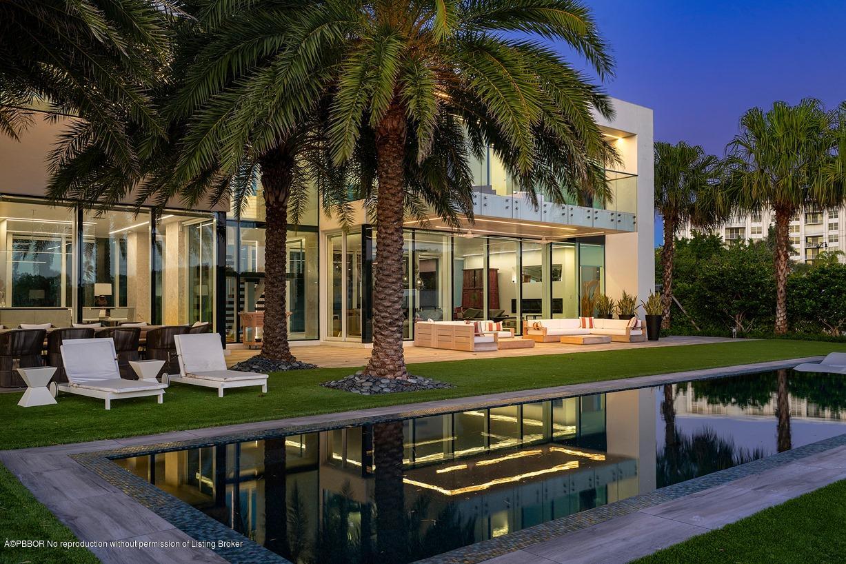 2299 Ibis Isle Road East Palm Beach, FL 33480 - Photo 3 of 37 a view of a house with pool and chairs