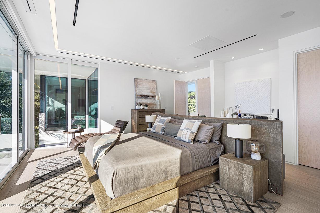 2299 Ibis Isle Road East Palm Beach, FL 33480 - Photo 21 of 37 a bedroom with double bed and a window