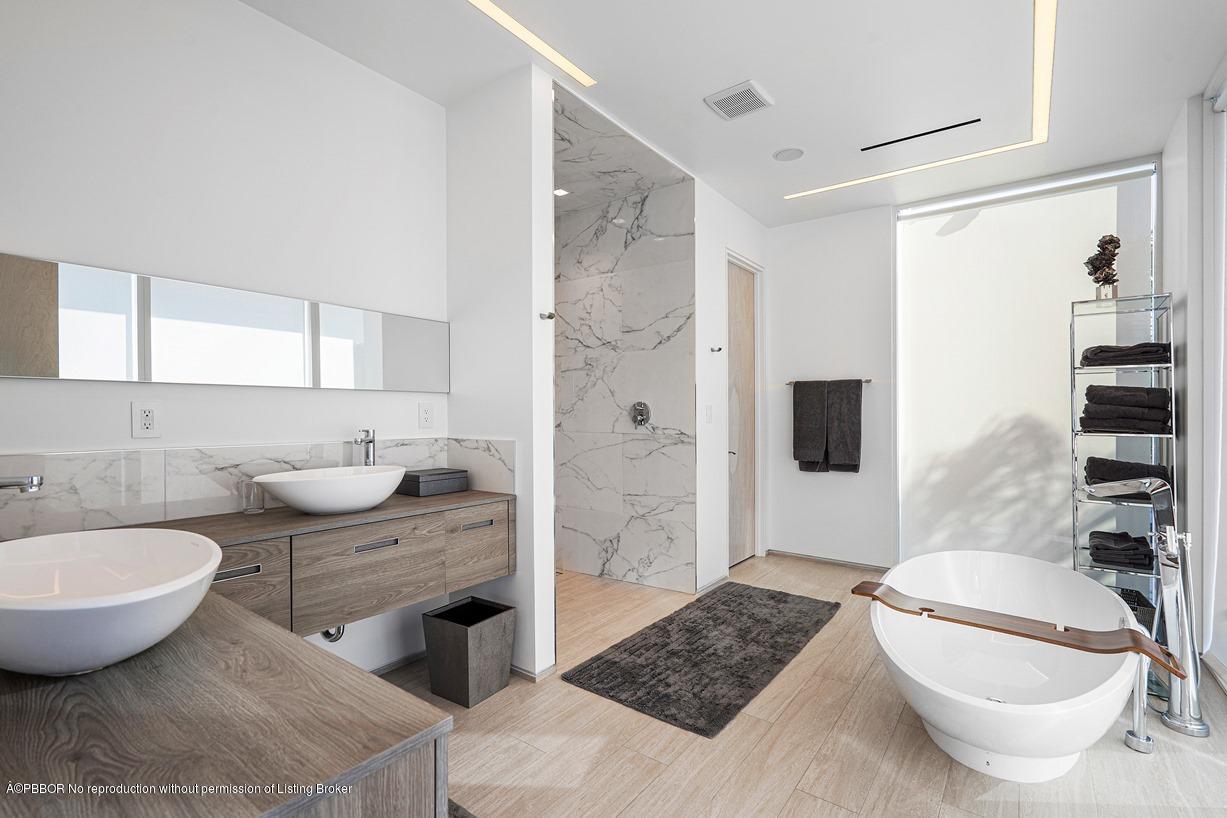 2299 Ibis Isle Road East Palm Beach, FL 33480 - Photo 22 of 37 a spacious bathroom with a granite countertop sink and a mirror