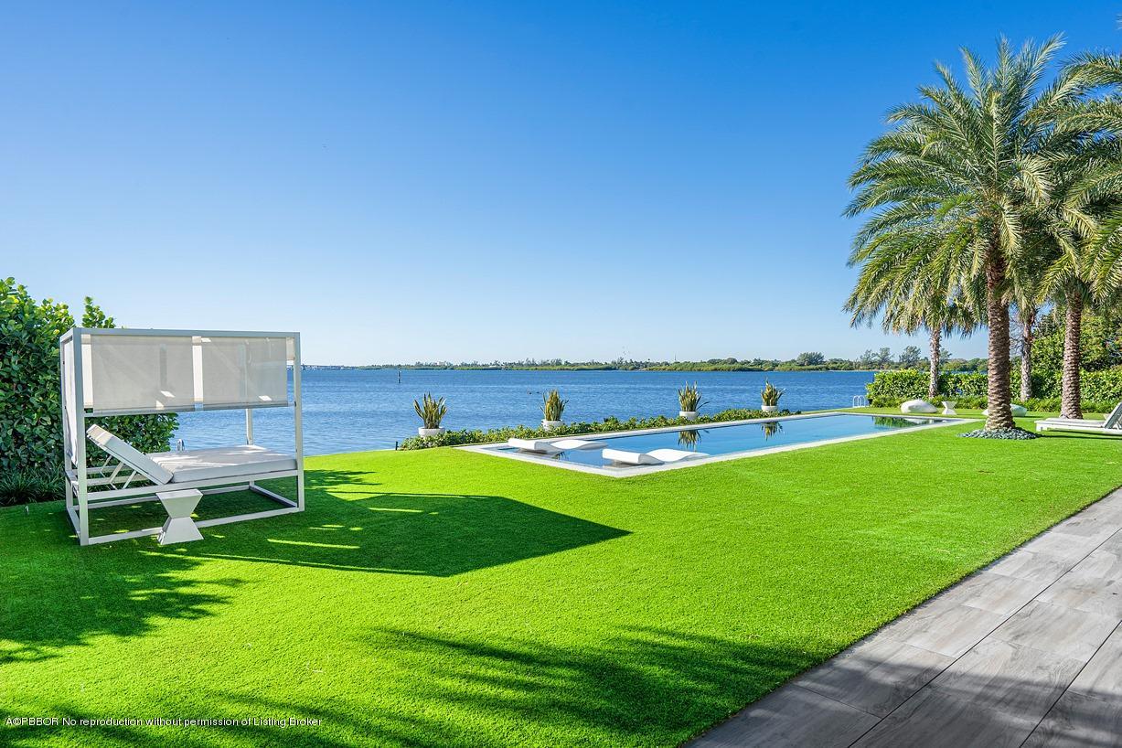 2299 Ibis Isle Road East Palm Beach, FL 33480 - Photo 23 of 37 a view of a house with a yard porch and sitting area