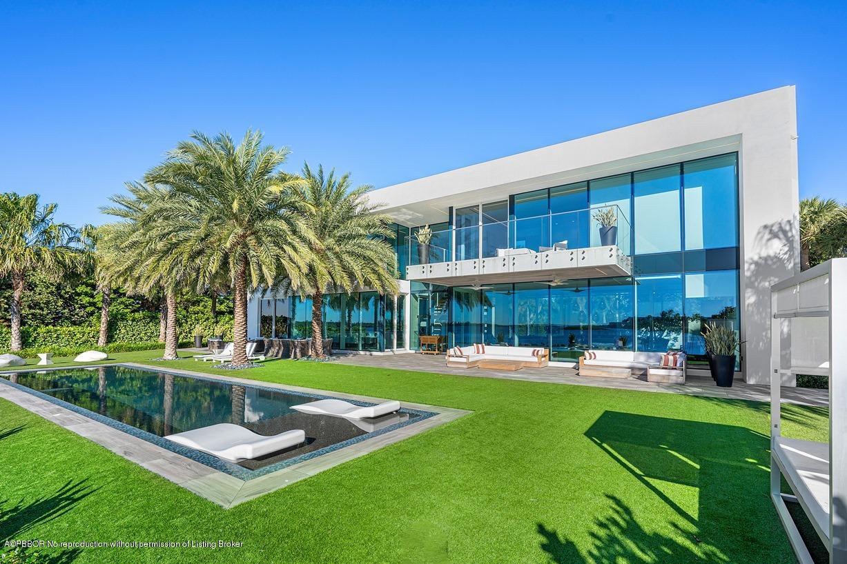 2299 Ibis Isle Road East Palm Beach, FL 33480 - Photo 24 of 37 a view of a house with a backyard porch and sitting area