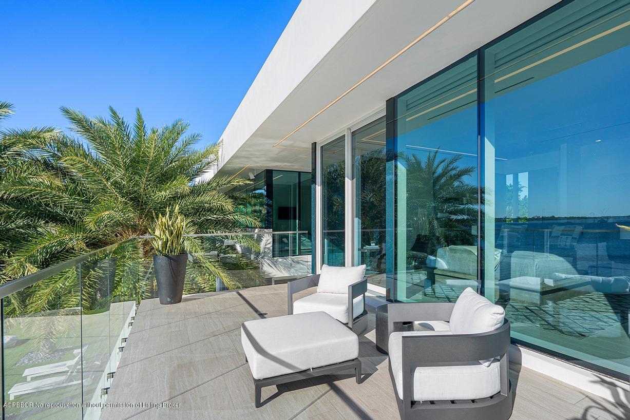 2299 Ibis Isle Road East Palm Beach, FL 33480 - Photo 36 of 37 a patio with yard glass top table and chairs