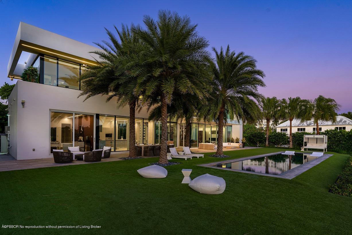 2299 Ibis Isle Road East Palm Beach, FL 33480 - Photo 8 of 37 a view of a swimming pool with a table and chairs