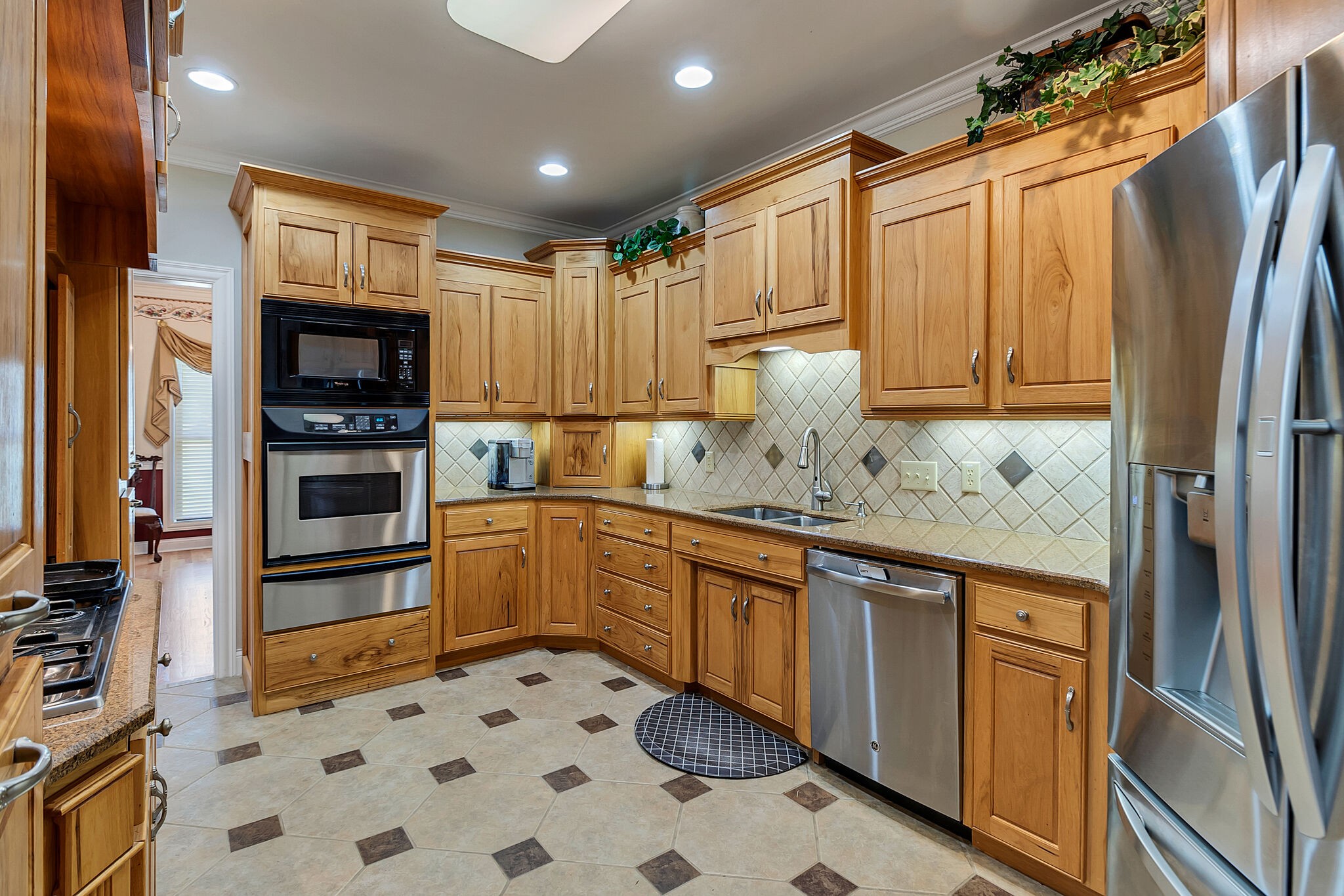3555 Coble Road Lewisburg, TN 37091 - Photo 11 of 45 a kitchen with granite countertop a refrigerator and a stove top oven