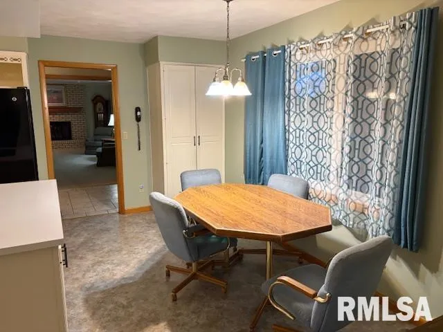 a dining room with furniture and window