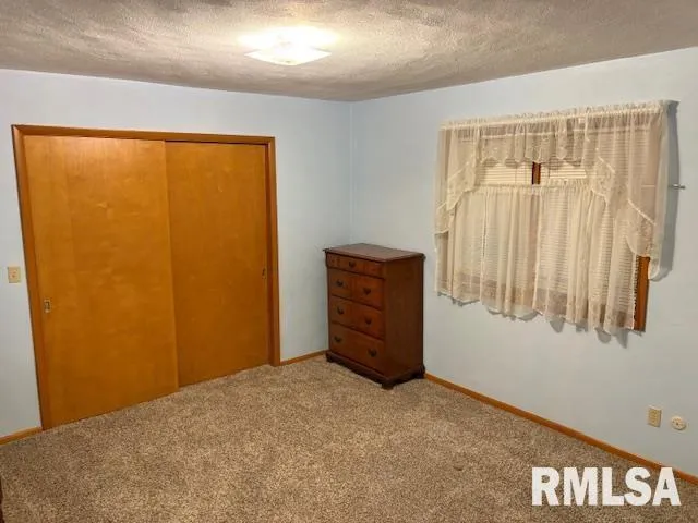 a bed sitting in a room next to a window