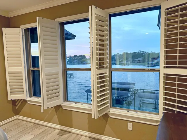 a spacious bedroom with a bed and large windows