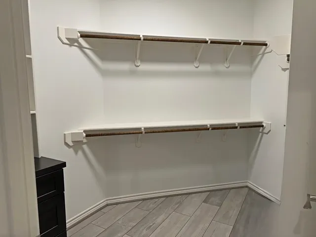 a spacious bedroom with a bed and large windows