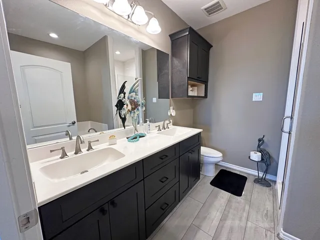 a kitchen with granite countertop a sink a window and potted plant