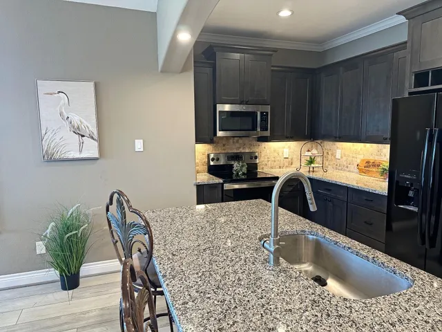 a living room with furniture fireplace and a large window