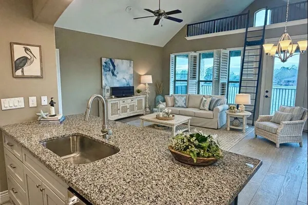 a living room with furniture and a floor to ceiling window