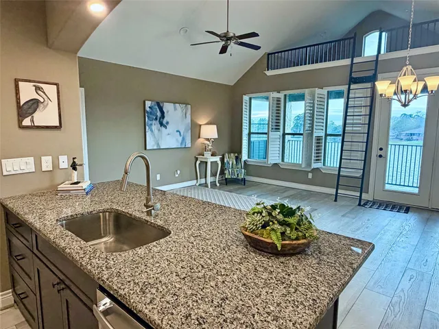 a front view of a house with yard and lake view