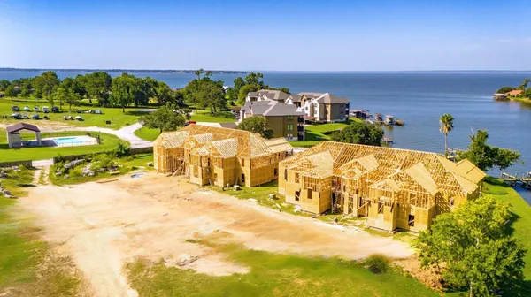 a green field with trees in the background
